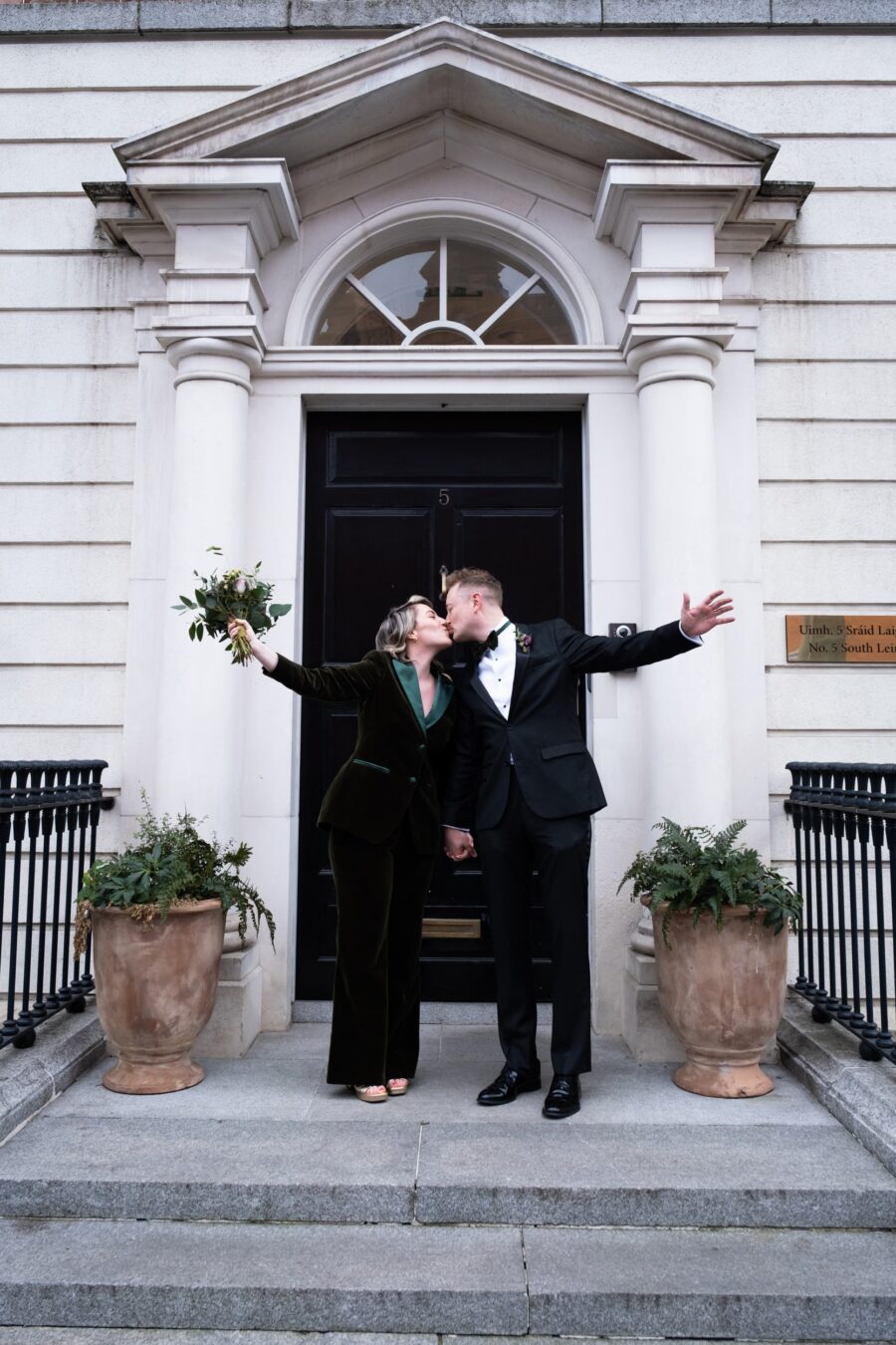 Bride and groom standing at the doorway of no 5 South Leinster Street at their wedding at The National Gallery of Ireland