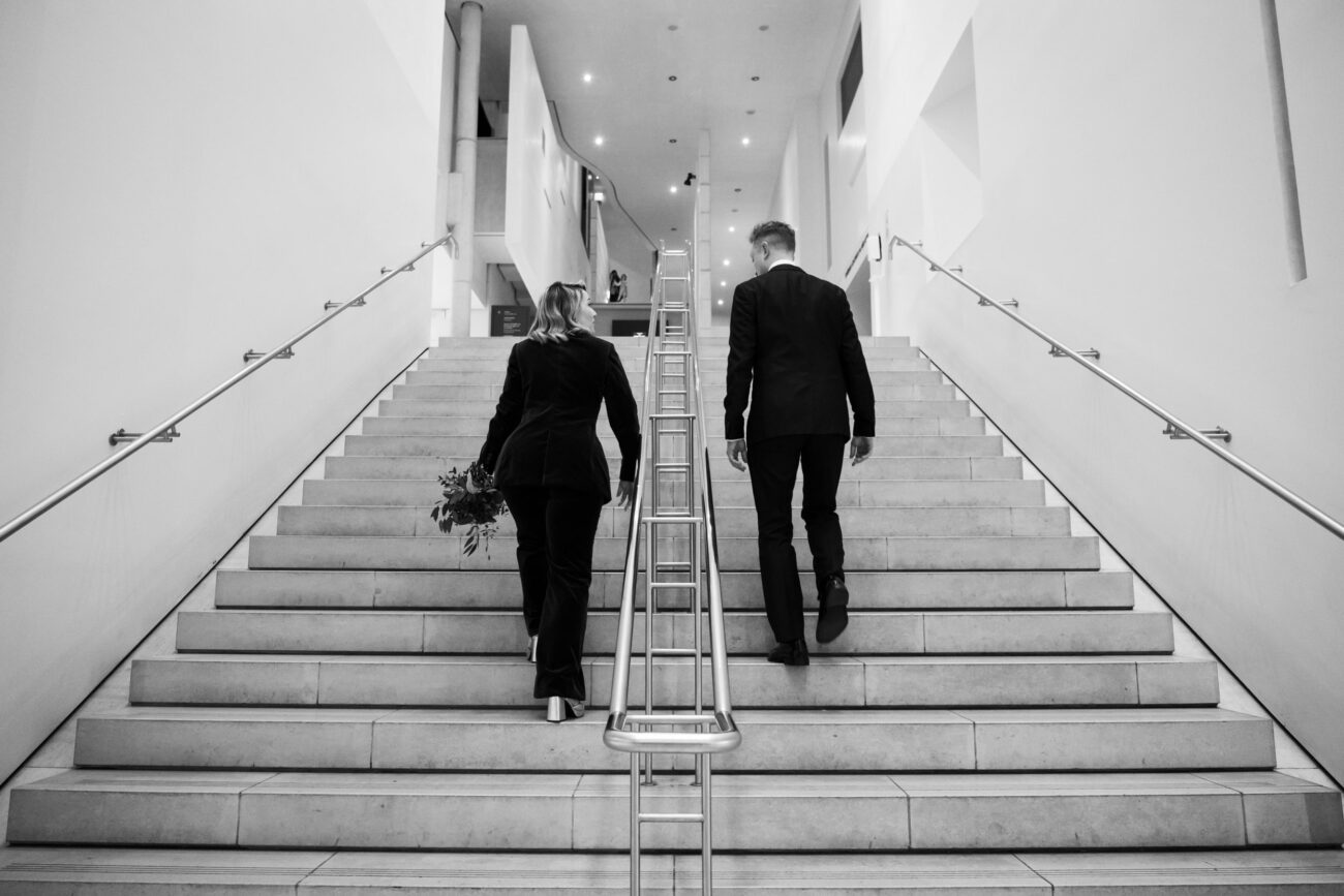 Bride and groom walking up the stairs to The National Gallery of Ireland