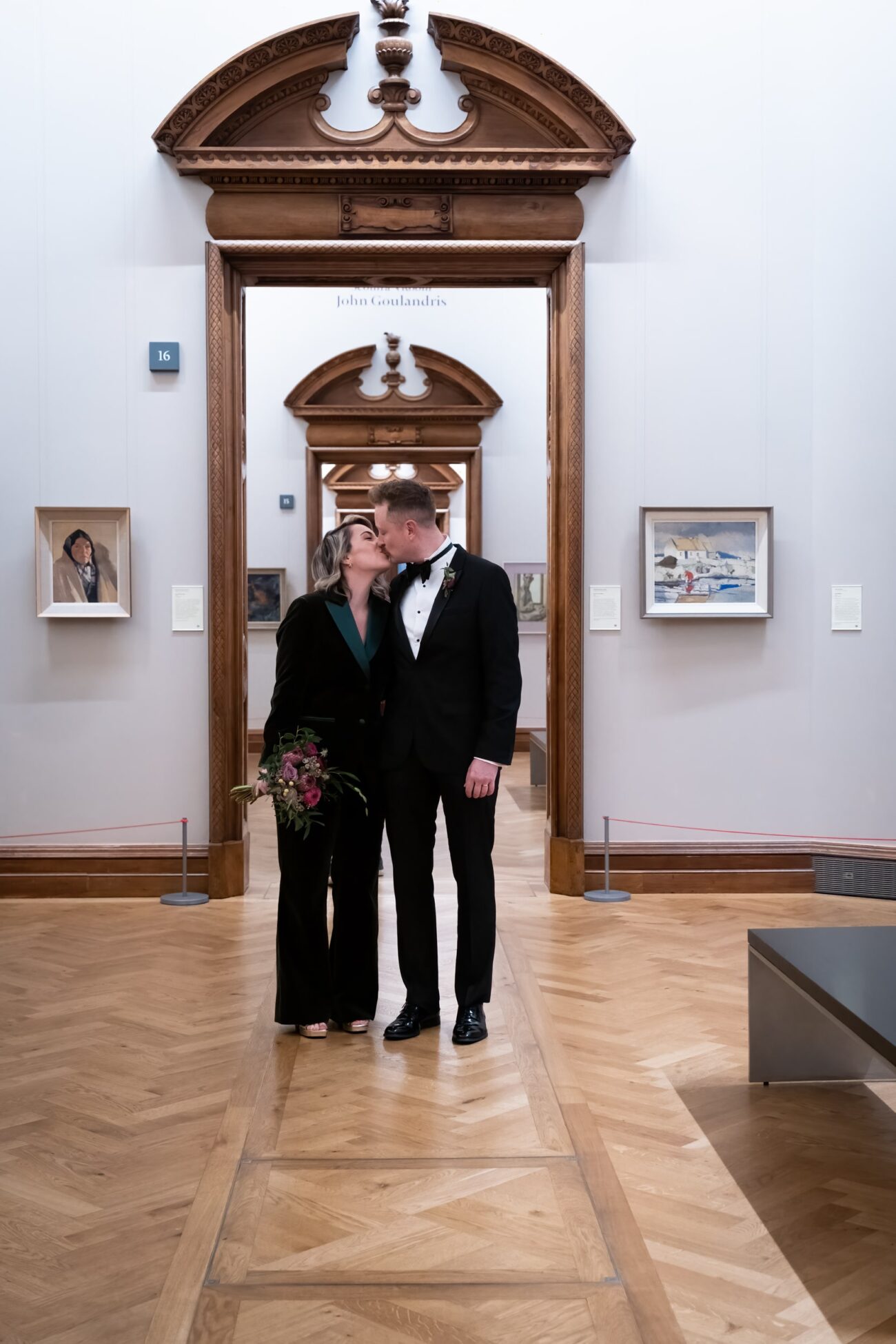 Bride and groom standing in the doorways on the painting rooms of The National Gallery of Ireland