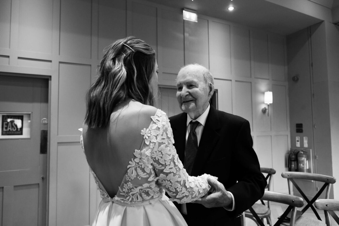 Grandfather congratulating his granddaughter at her wedding ceremony at The Clarence Hotel