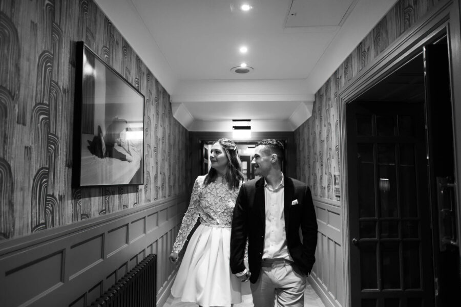 Bride and groom walking down the hallway at The Clarence Hotel. Intimate wedding in Dublin