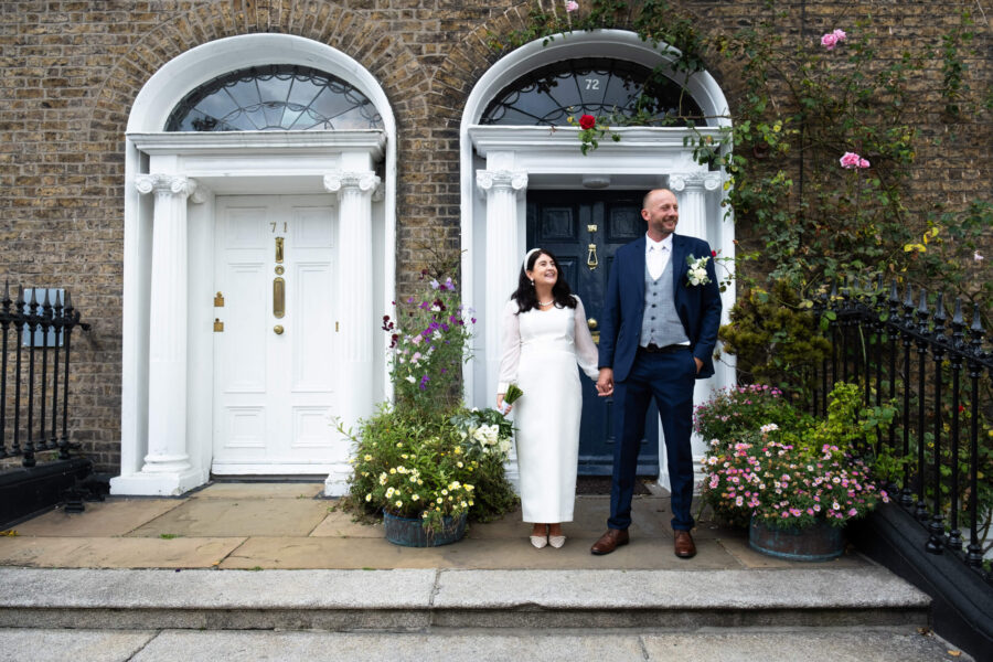 Couple standing outside Georgian doors un Dublin City.