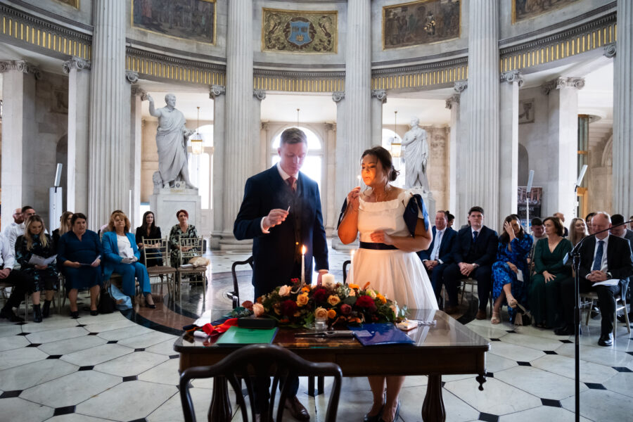 couple blowing out the wedding candle at Dublin City Hall, Dublin City Hall wedding