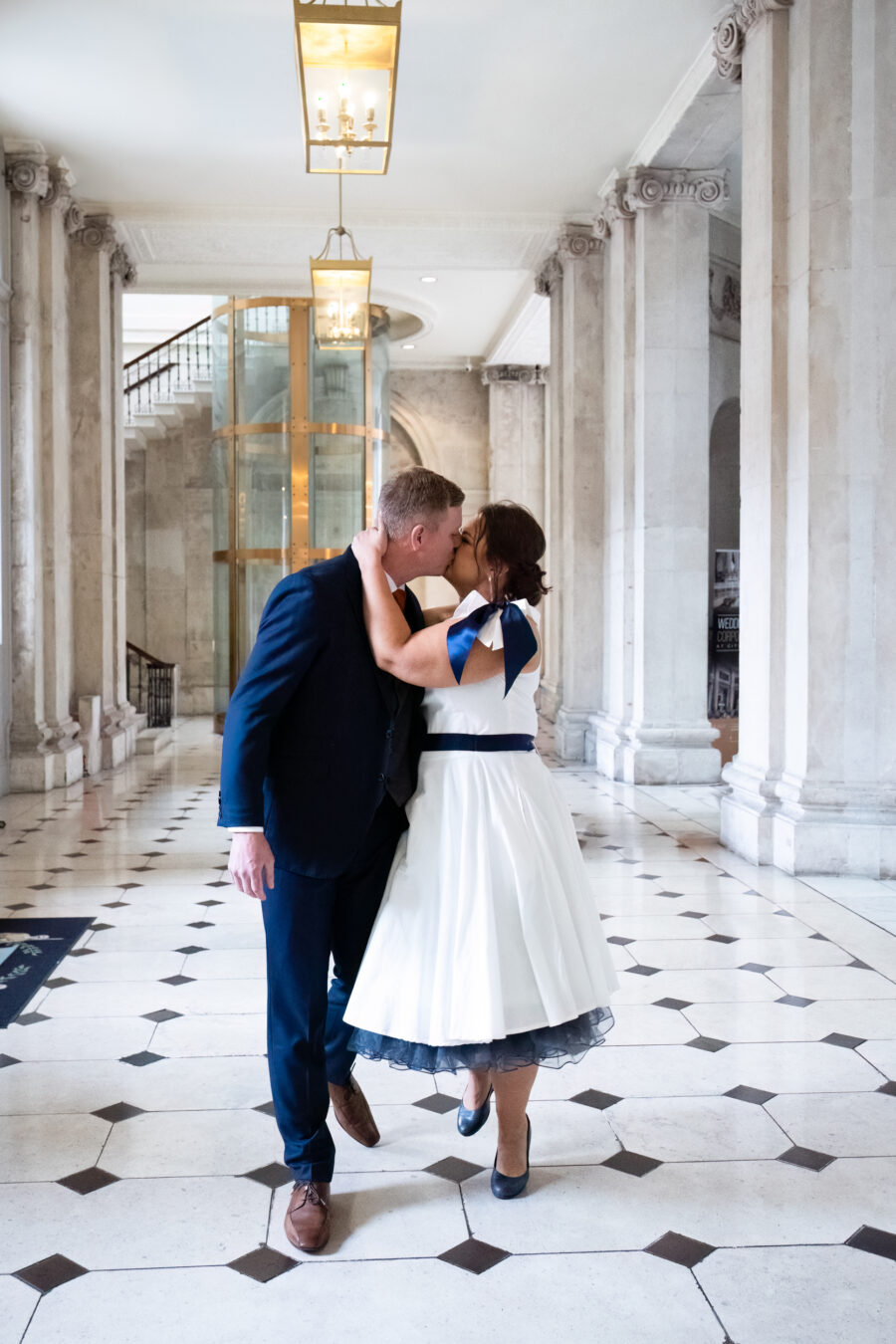 bride and groom kissing after they have walking down the aisle at Dublin City Hall