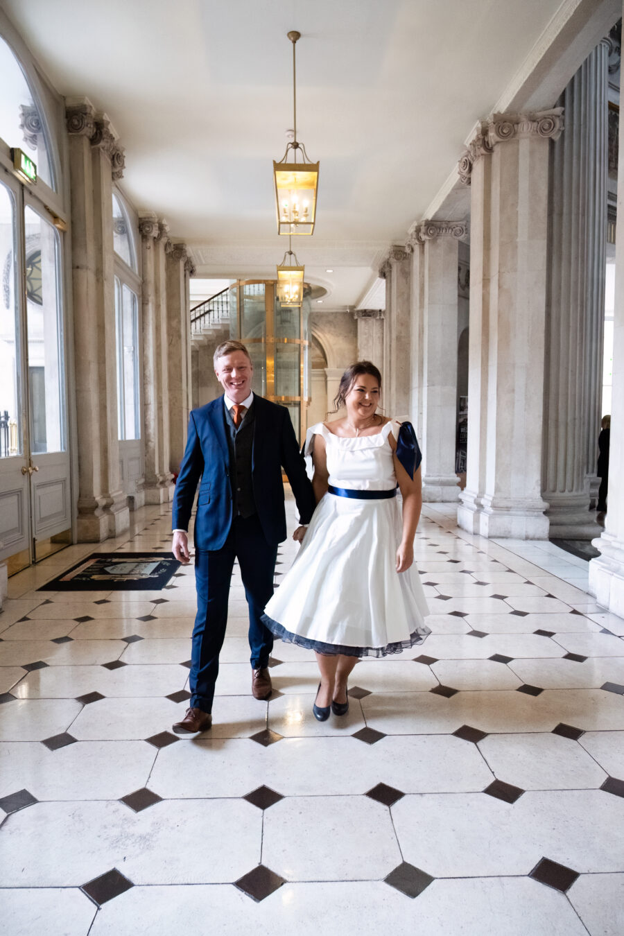 bride and groom laughing after they have walking down the aisle at Dublin City Hall