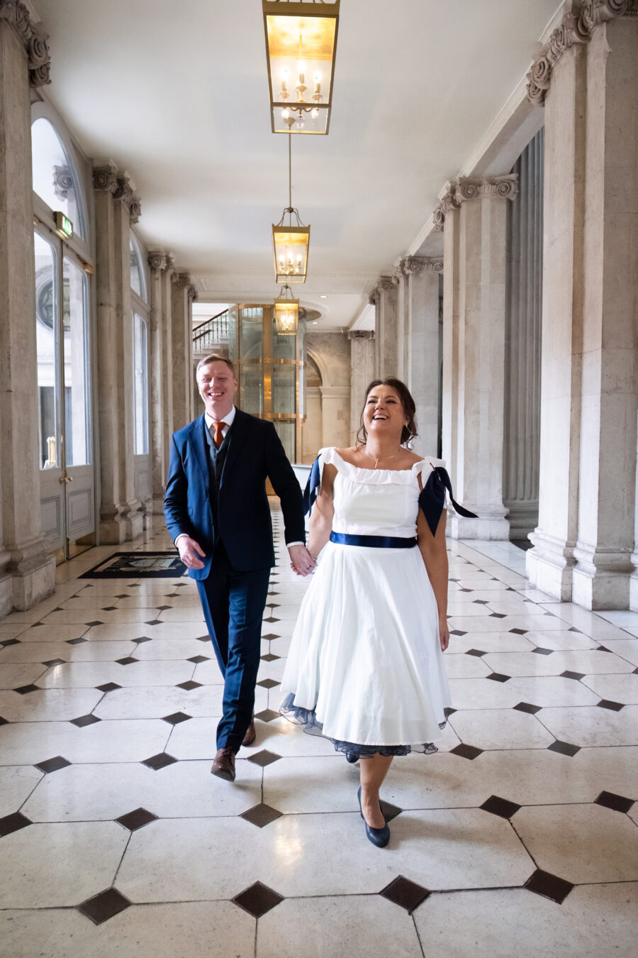 bride and groom laughing after they have walking down the aisle at Dublin City Hall