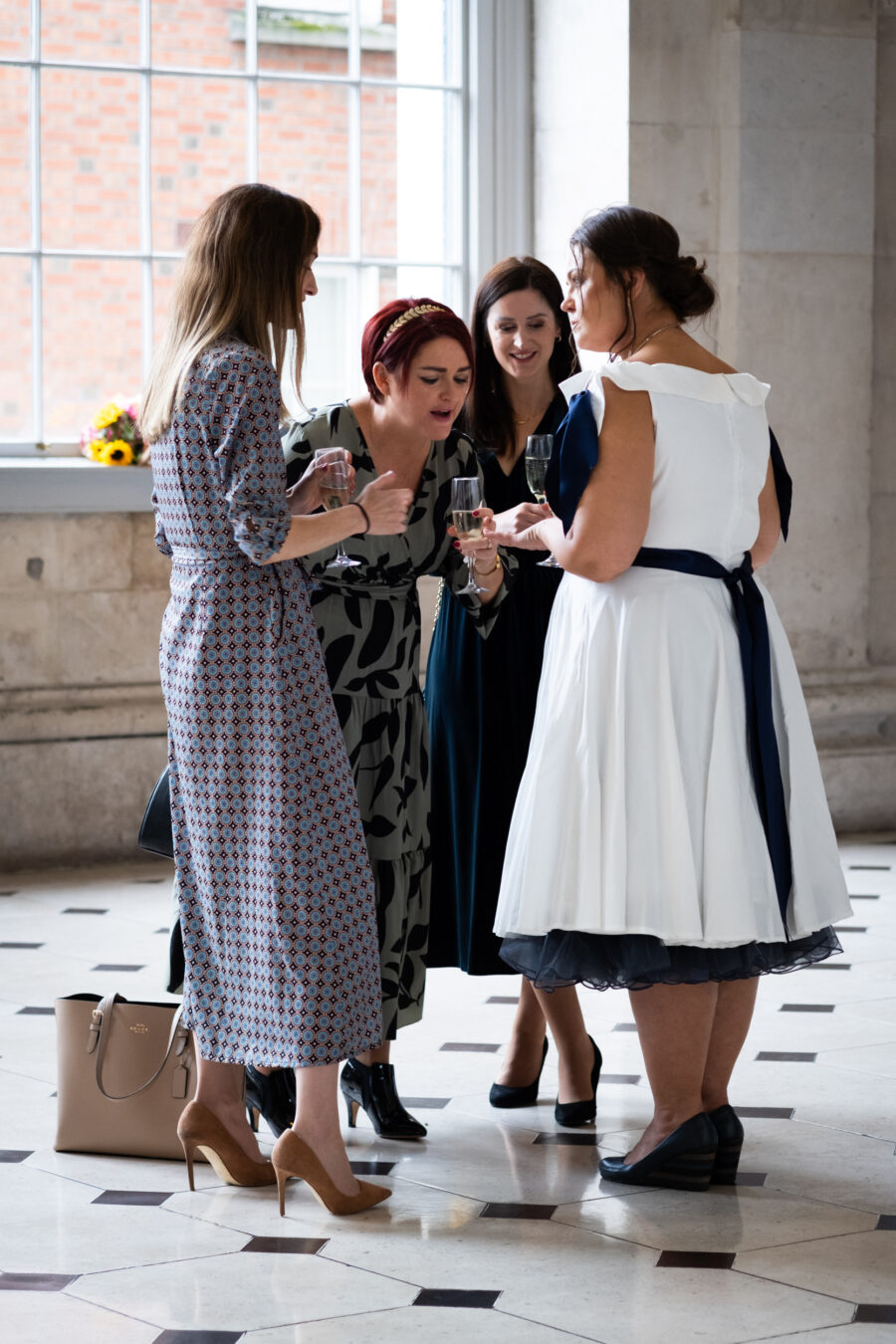 guests looking at brides ring during cocktail hour at Dublin City Hall