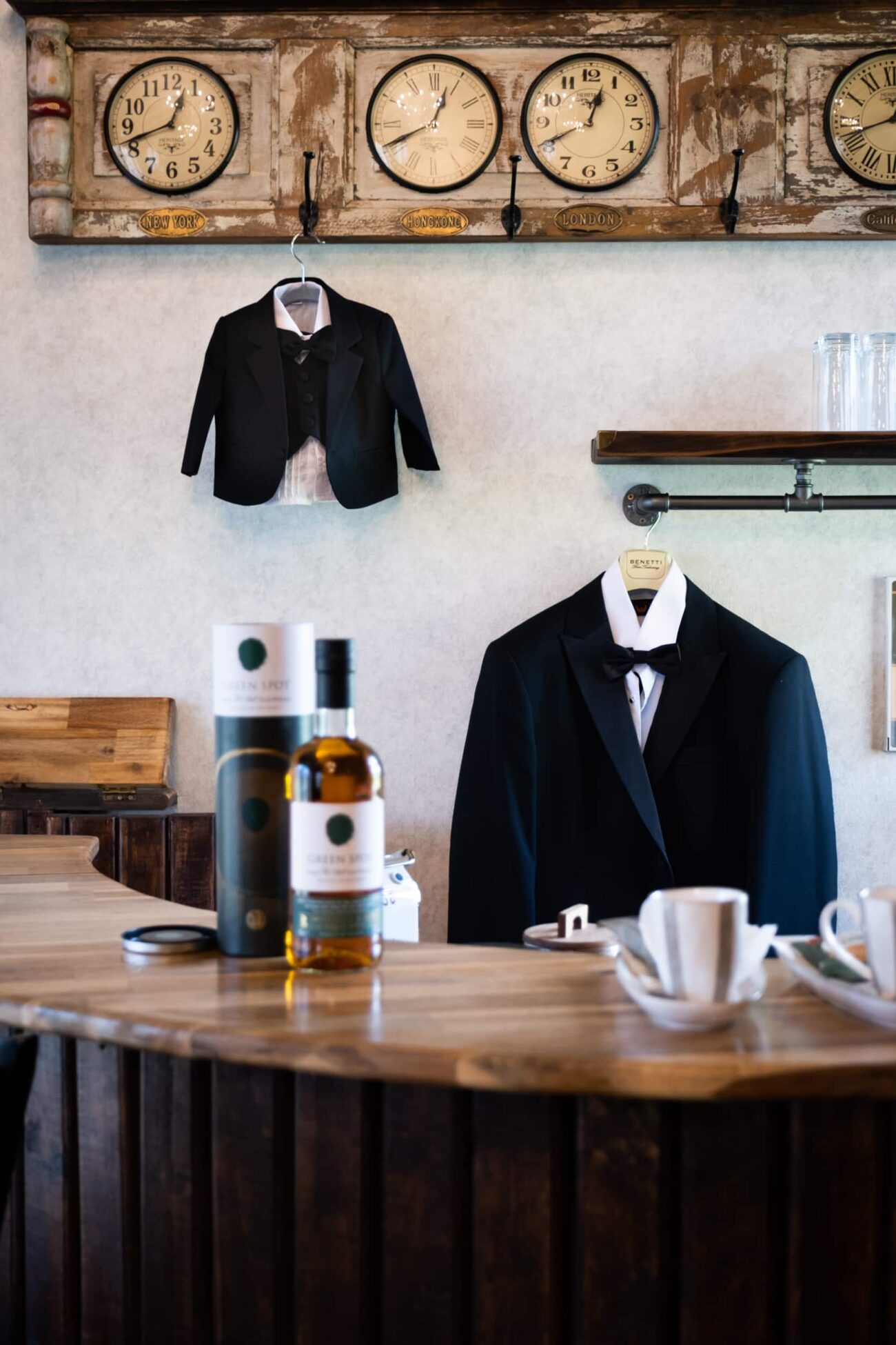 detail shots of the grooms suit and his sons suit handing up in the coach house at Ballymagarvey Village