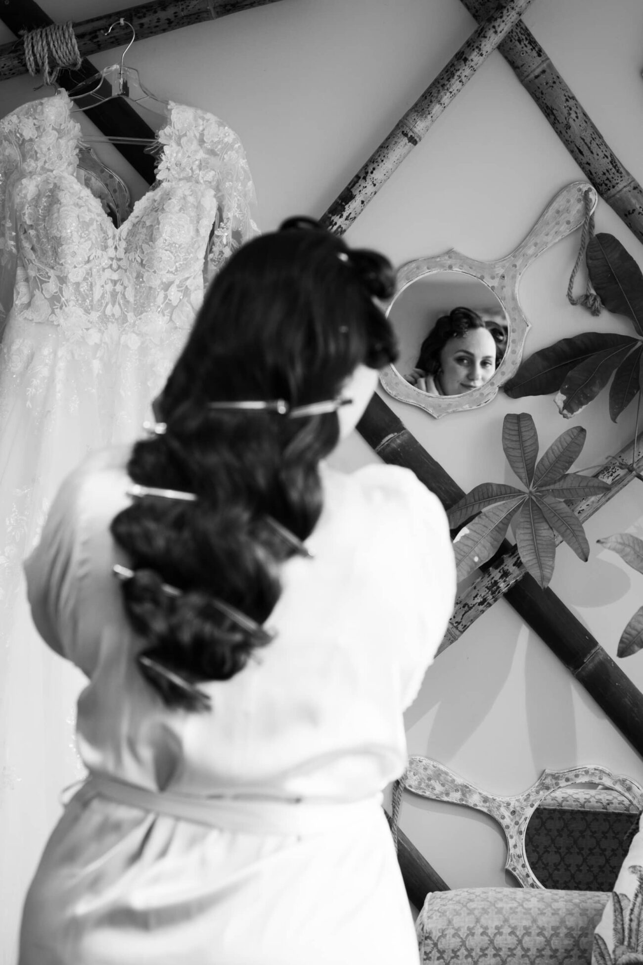 Bride looking in the mirror and fixing her earrings during bridal prep at Ballymagarvey Village