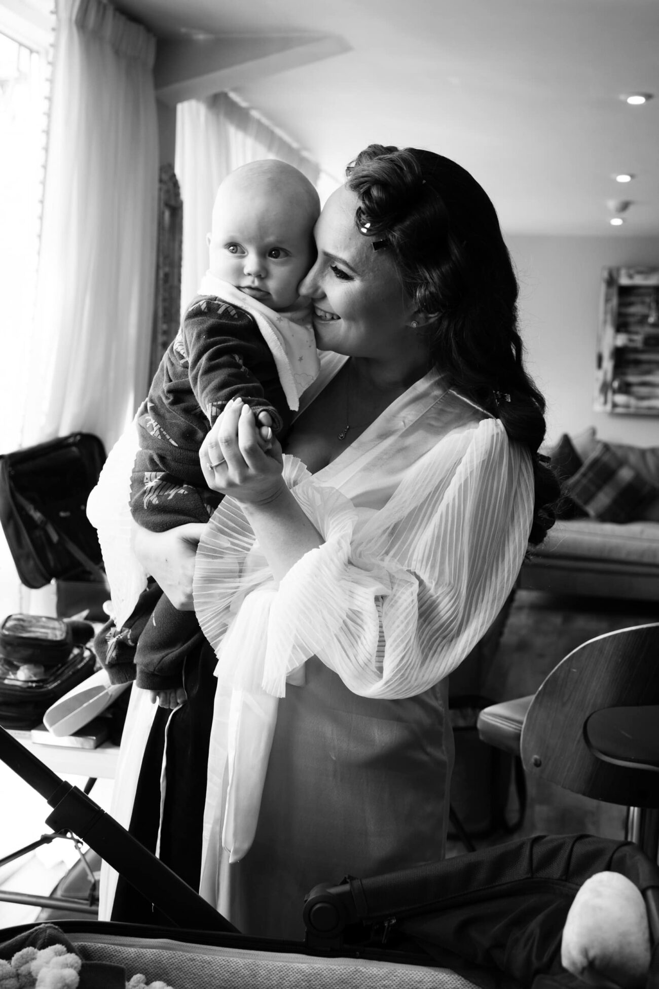 Biide cuddling her aby during bridal prep at Ballymagarvey Village