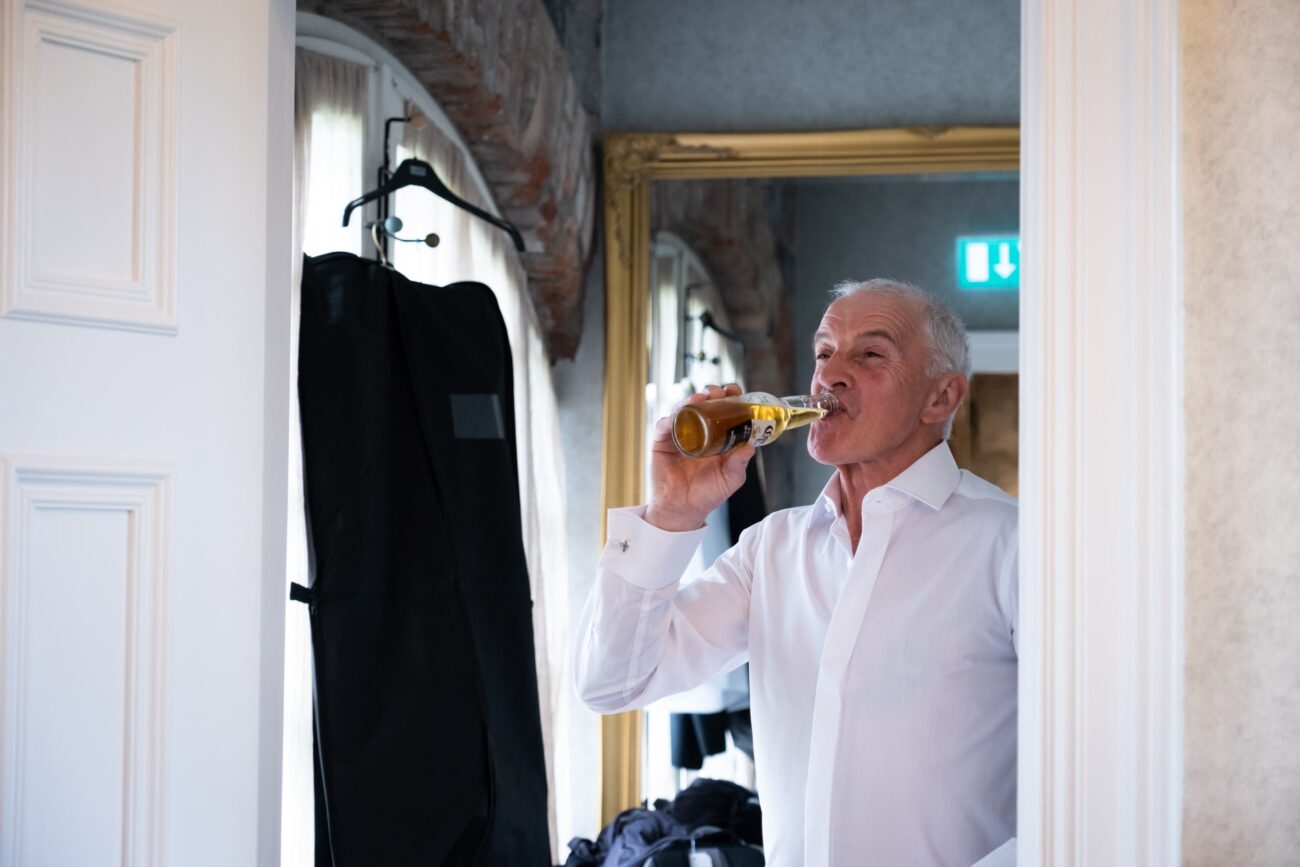 father of the groom drinking a beer at Ballymagarvey Village