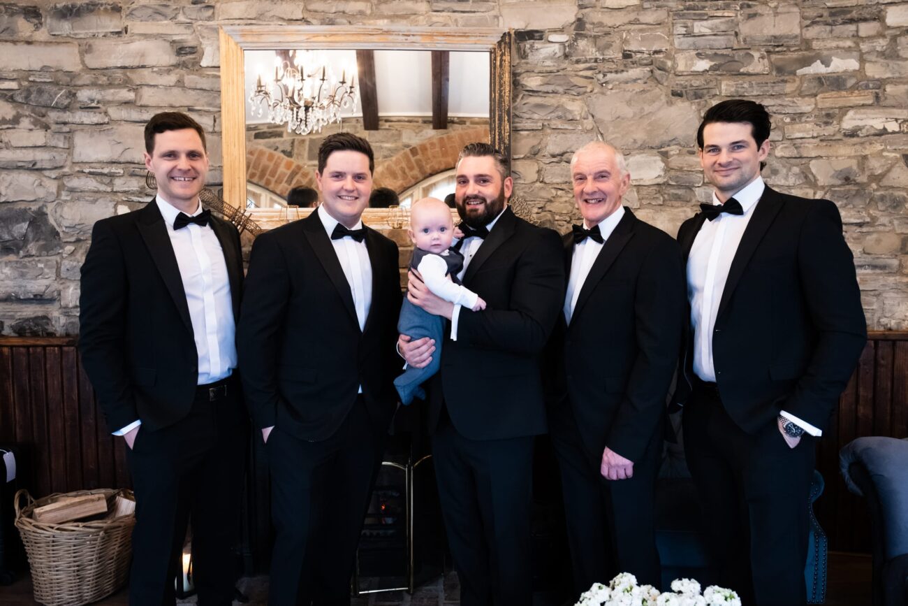 groomsmen and the baby boy all dressed up ion the coach house of Ballymagarvey Village