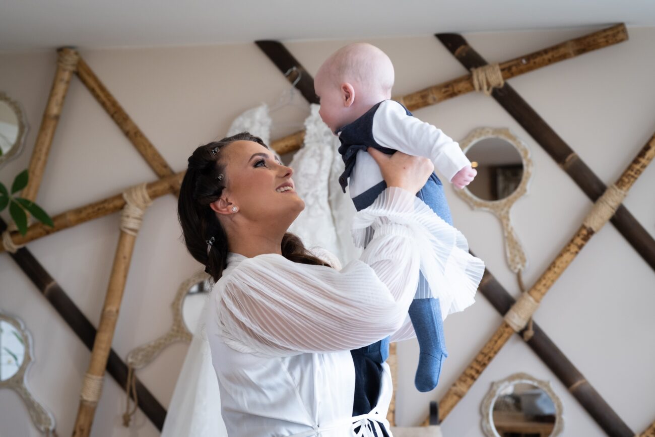 bride looking at her little boy during bridal prep at Ballymagarvey Village