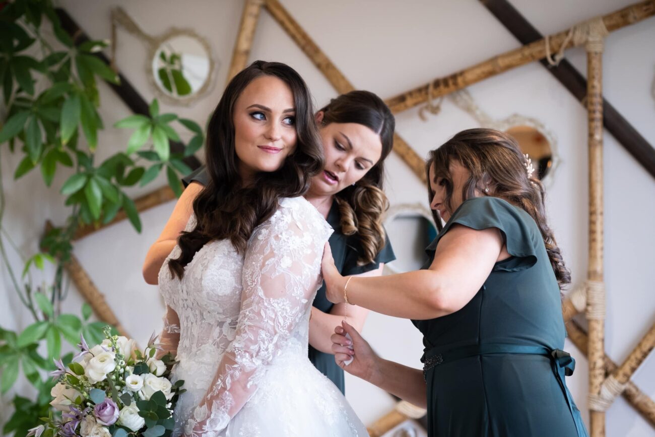 bridemaides fixing the brides dress at Ballymagarvey Village