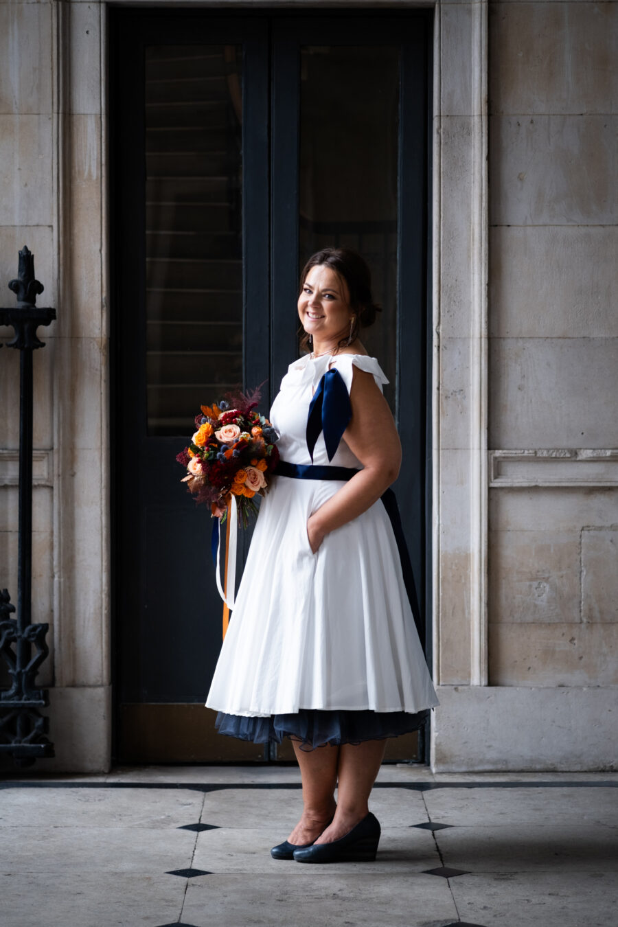 Bride portrait, facing the camera at the front balcony of Dublin City Hall