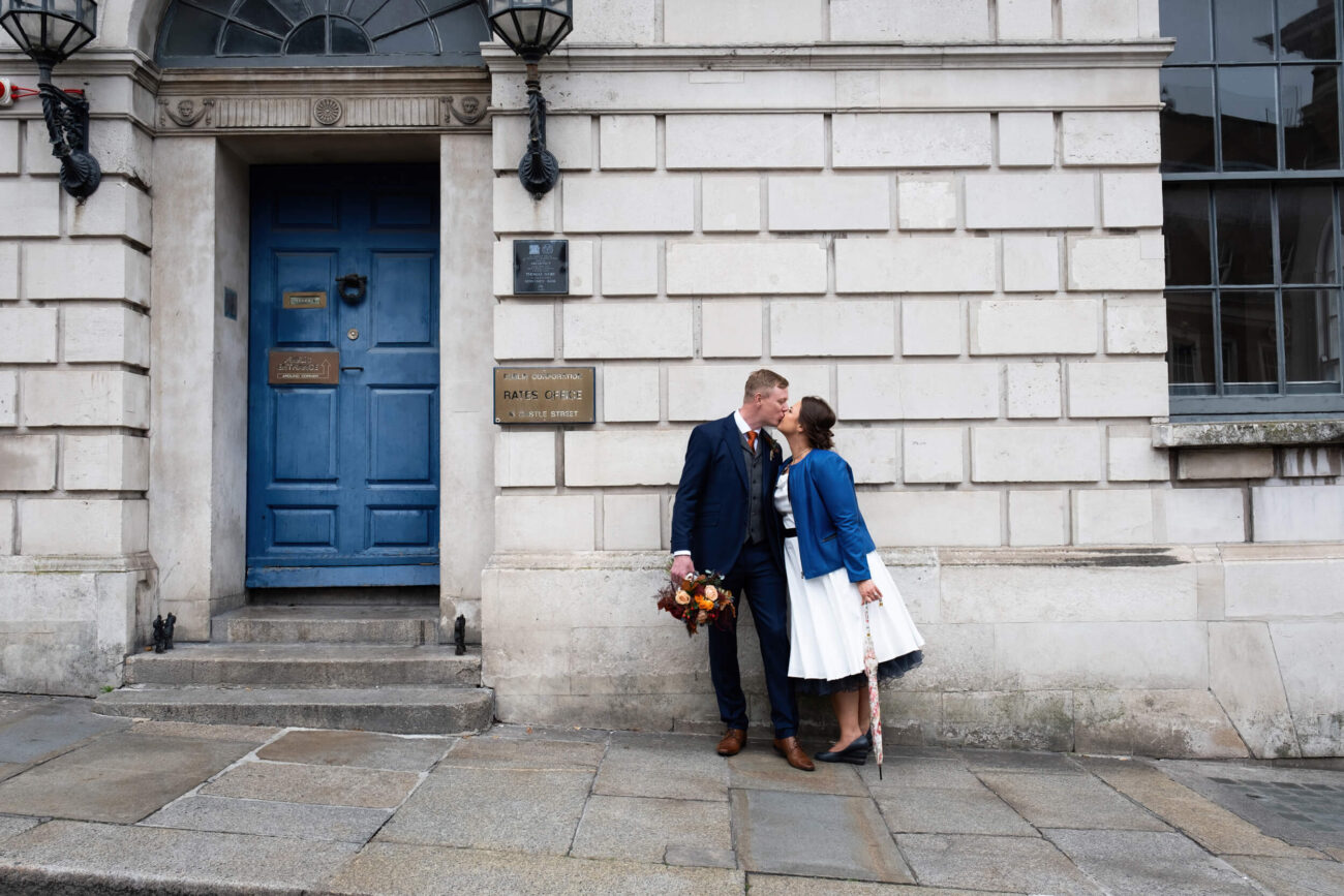 couple kissing against a wall of a building in Dublin City