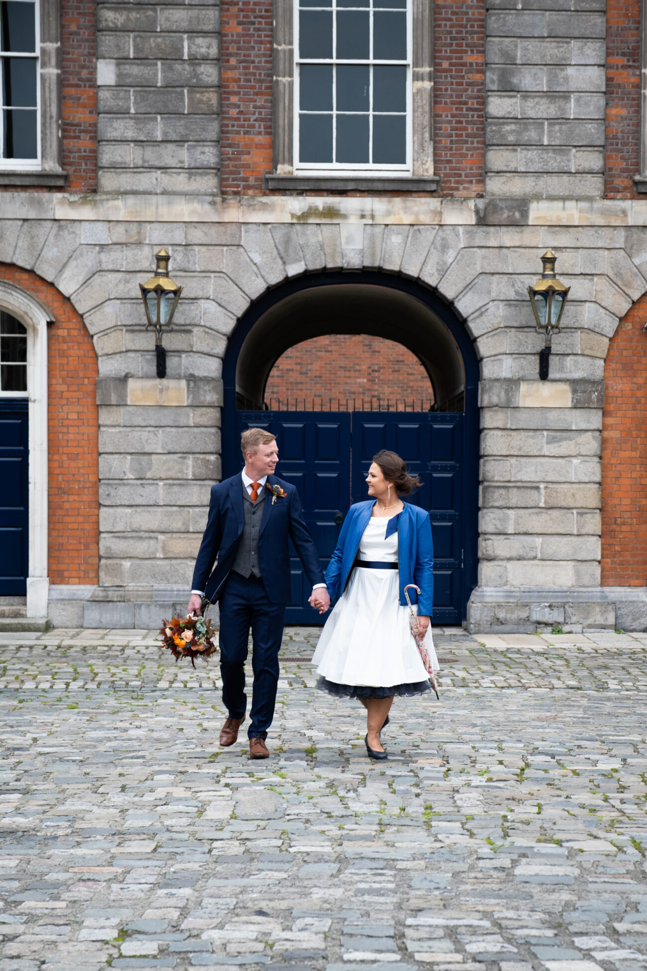 couple walking hands walking in the square of Dublin Castle
How to relax in front of the camera, candid wedding photographer in Dublin