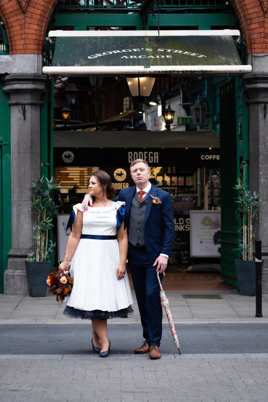 couple standing outside of Georges Street Arcade in Dublin city