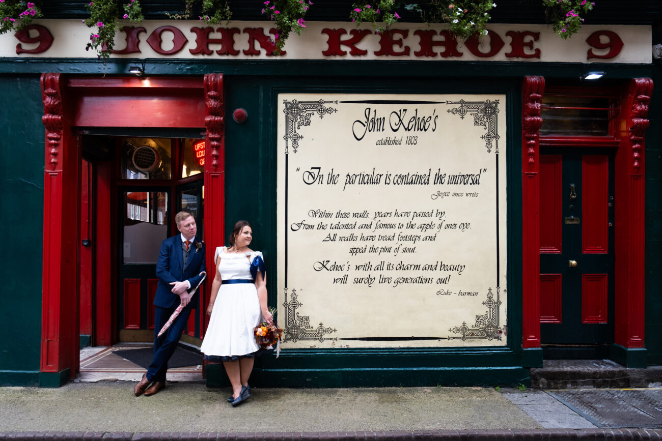 bride and groom standing outside Keoghs pubs in Dublin City