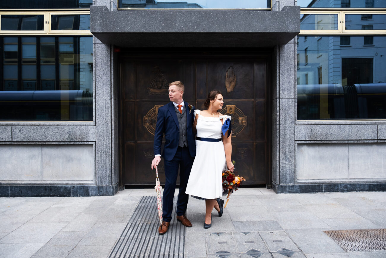 Couple standing outside old entrance of central bank