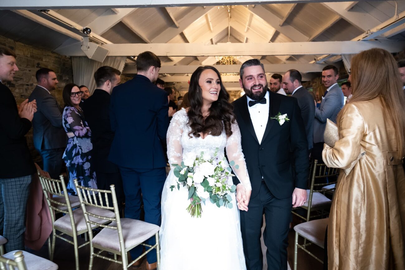 Bride and groom walking down the aisle at Ballymagarvey wedding ceremony