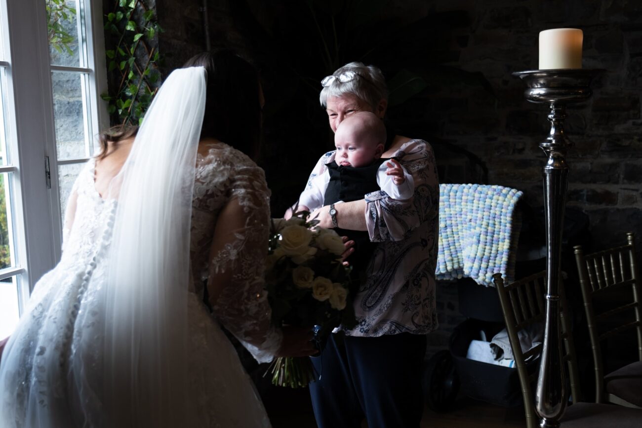 bride looking at her baby son 