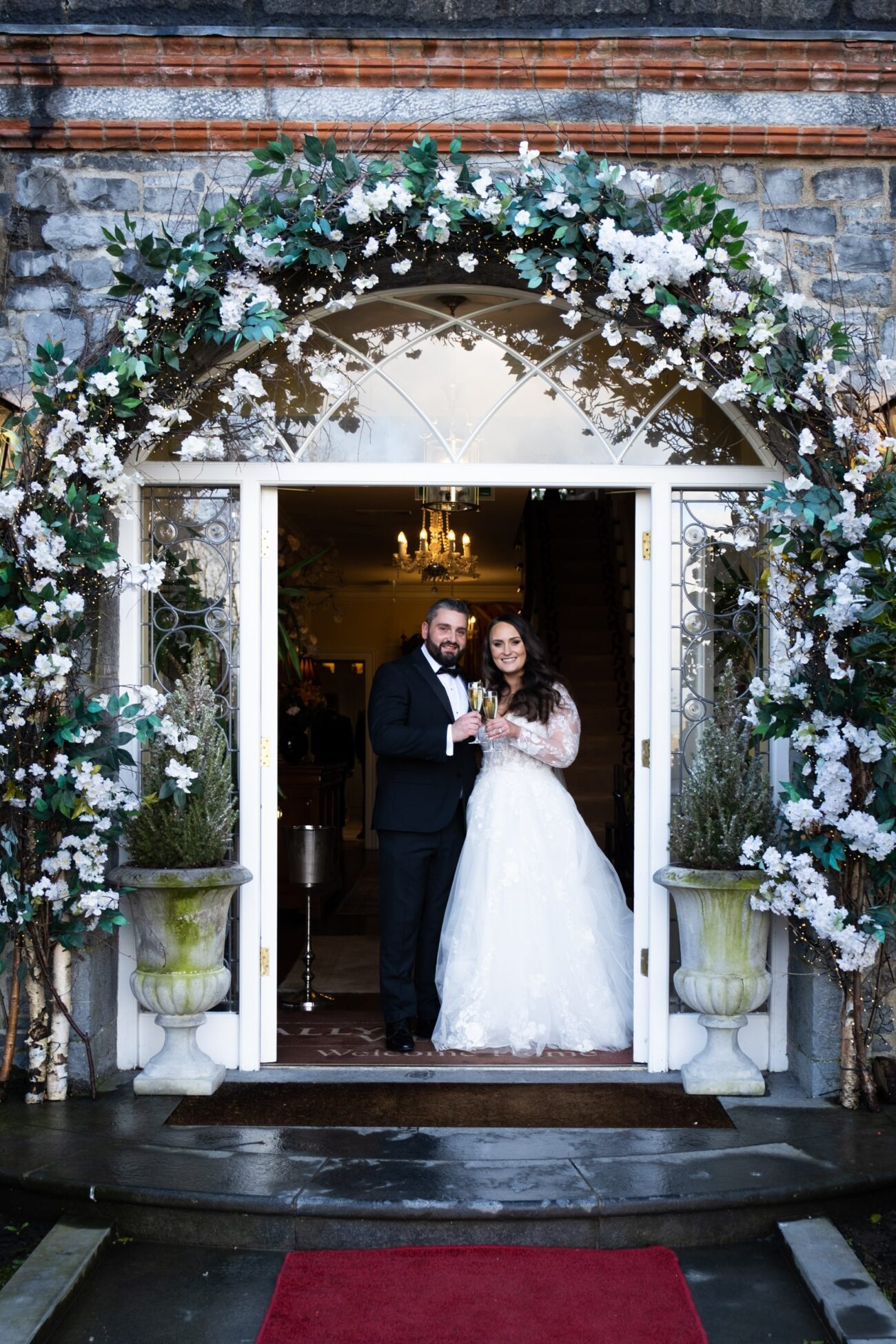 bride and groom outside the front door of Manor House at Ballymagarvey Village