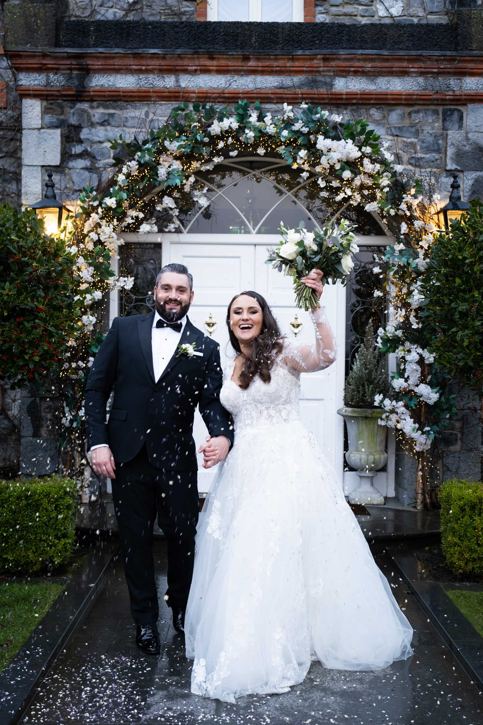 bride and groom walking through confetti