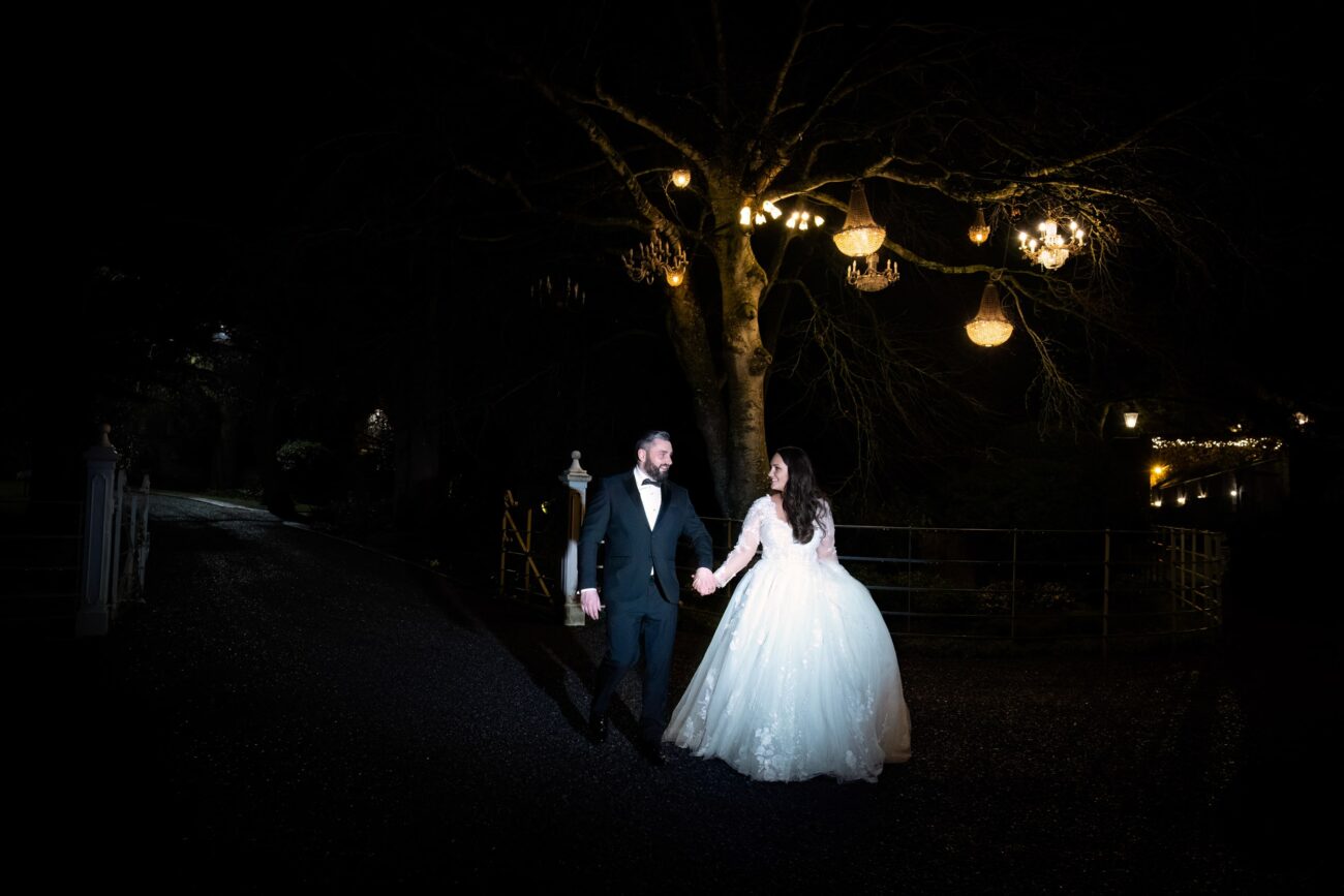 nightime shot of bride and groom at Ballymagarvey Village chandelier tree