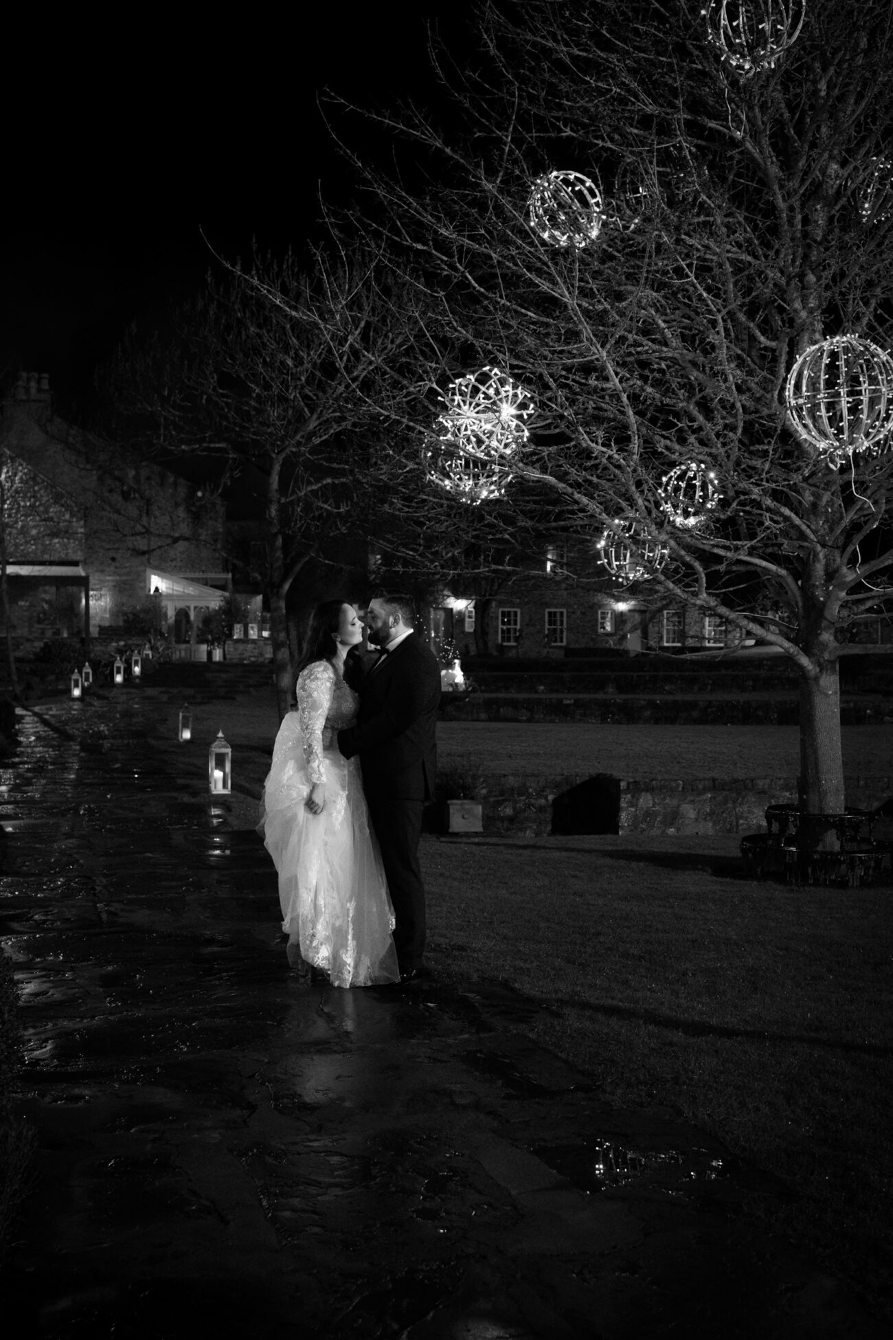 nightime shot of bride and groom at Ballymagarvey Village couryard