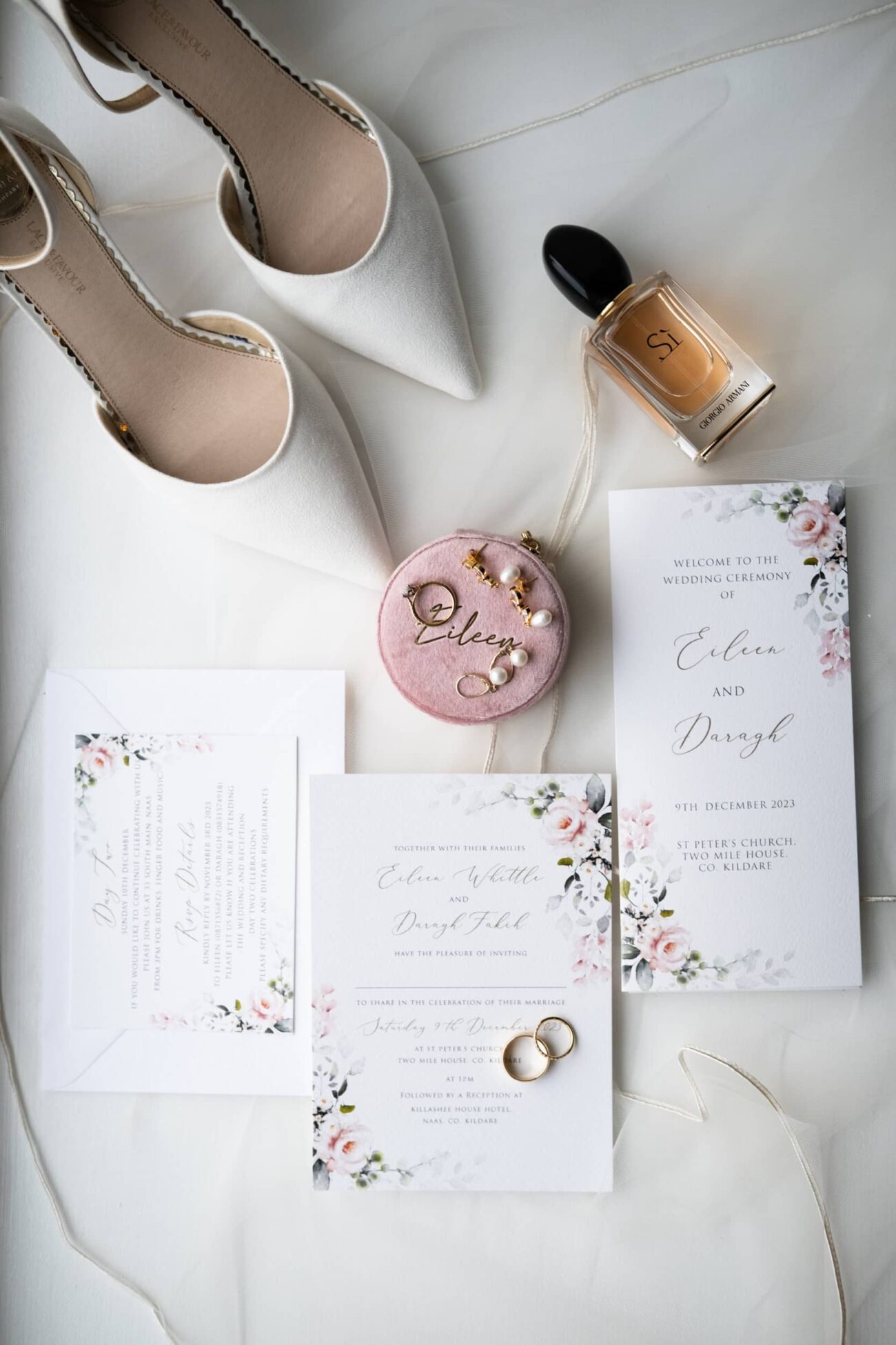 flat-lay wedding invitation, shoes and jewellery