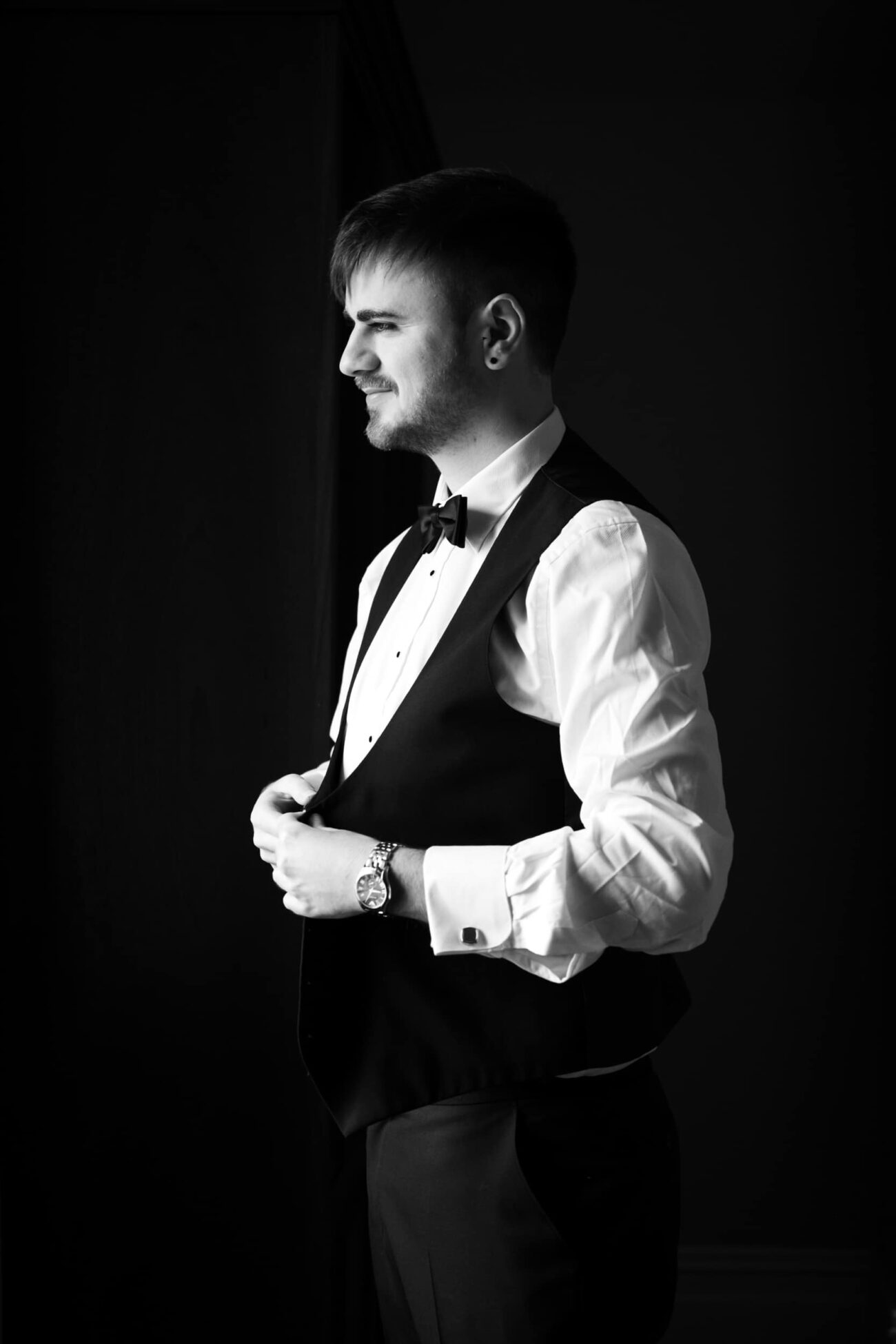 Groom fixing his waistcoat during groom prep at Killashee hotel