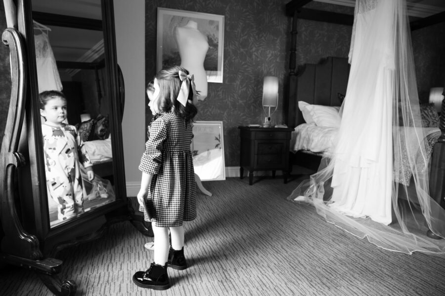 Flower girls looking in the mirror at Killashee Hotel. Wedding at Killashee Hotel