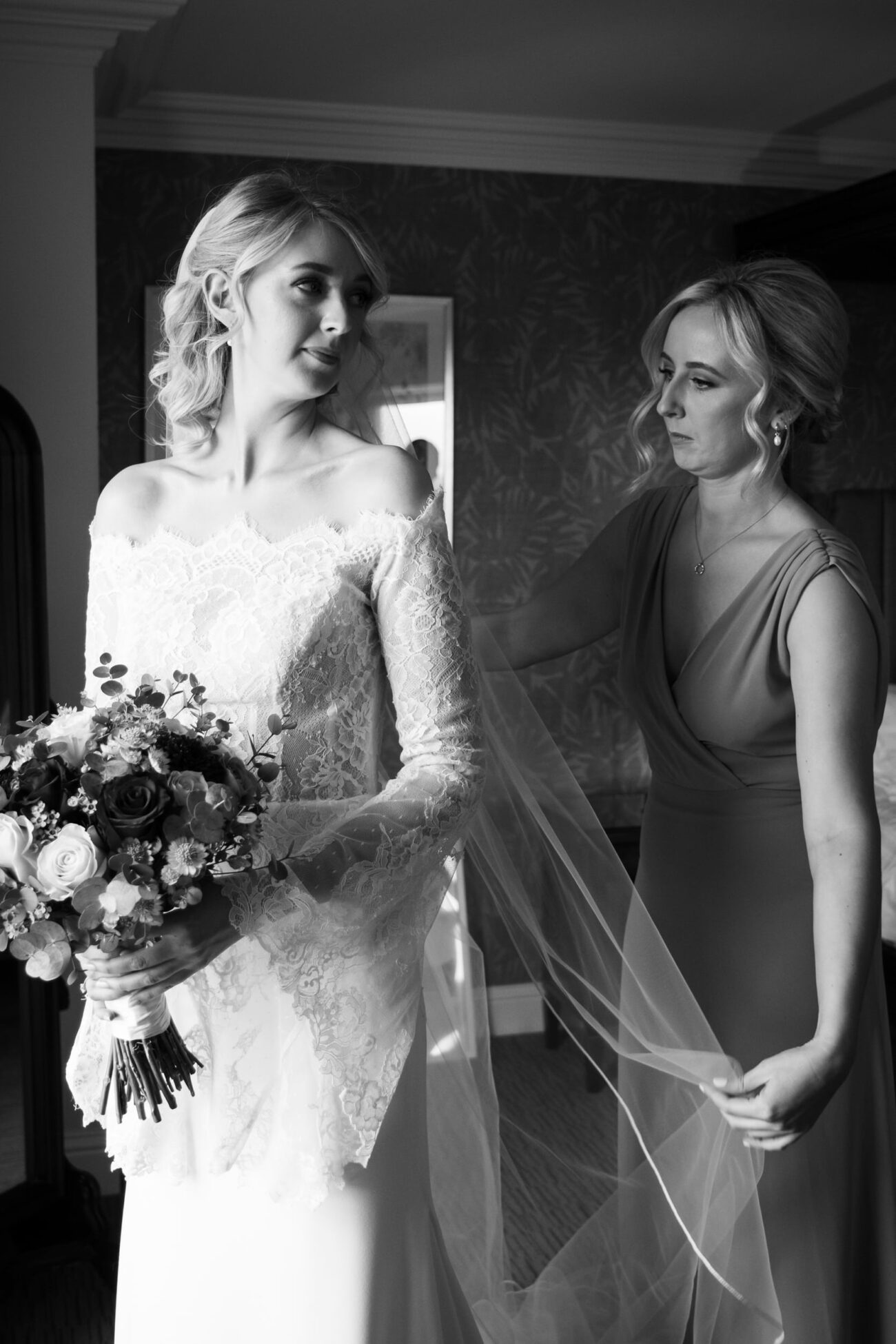 Bridesmaid fixing the brides veil at Killashee Hotel