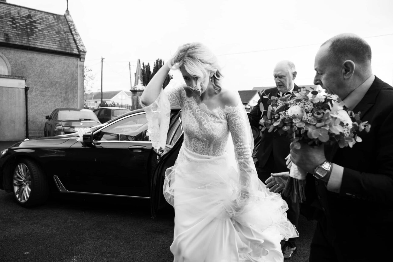 Bride walking out of the car to the ceremony at Two Mile House, Kildare