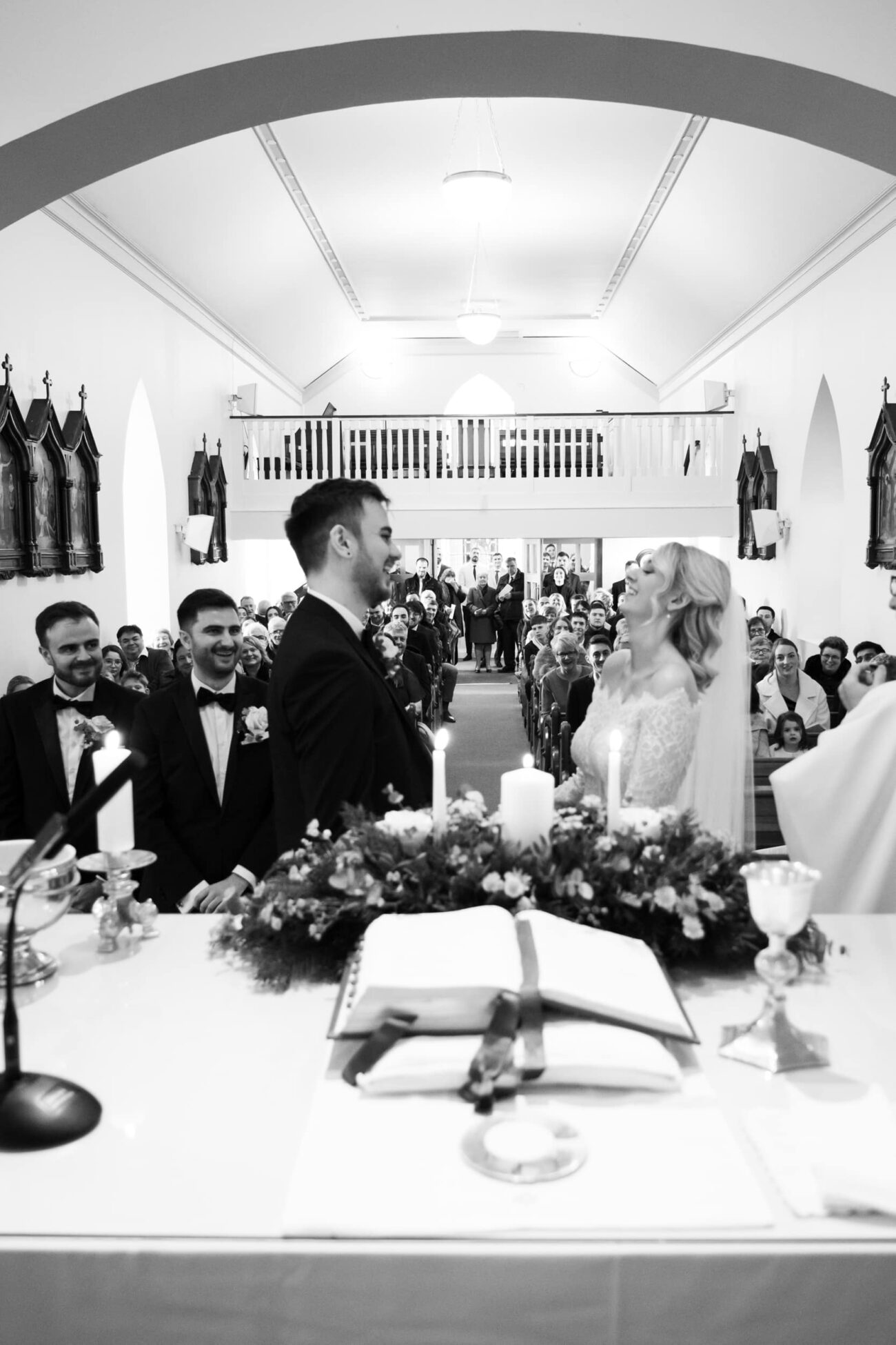 Bride and rgoom making their vows at St Peters Church, Two Mile House