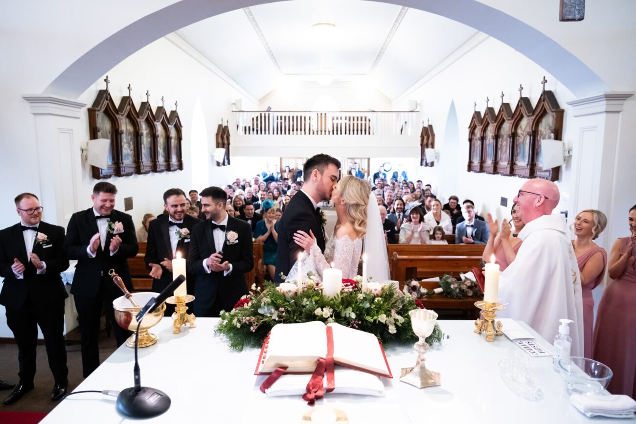 wedding ceremony at Two Mile House, bride kissing the Groom