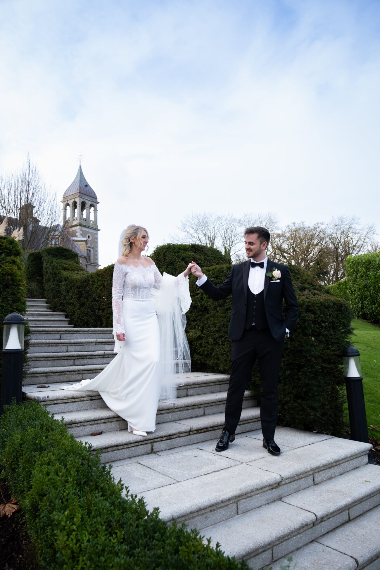 Groom walking the bride down the stairs in the grounds of Killashee Hotel, Killshee Hotel wedding