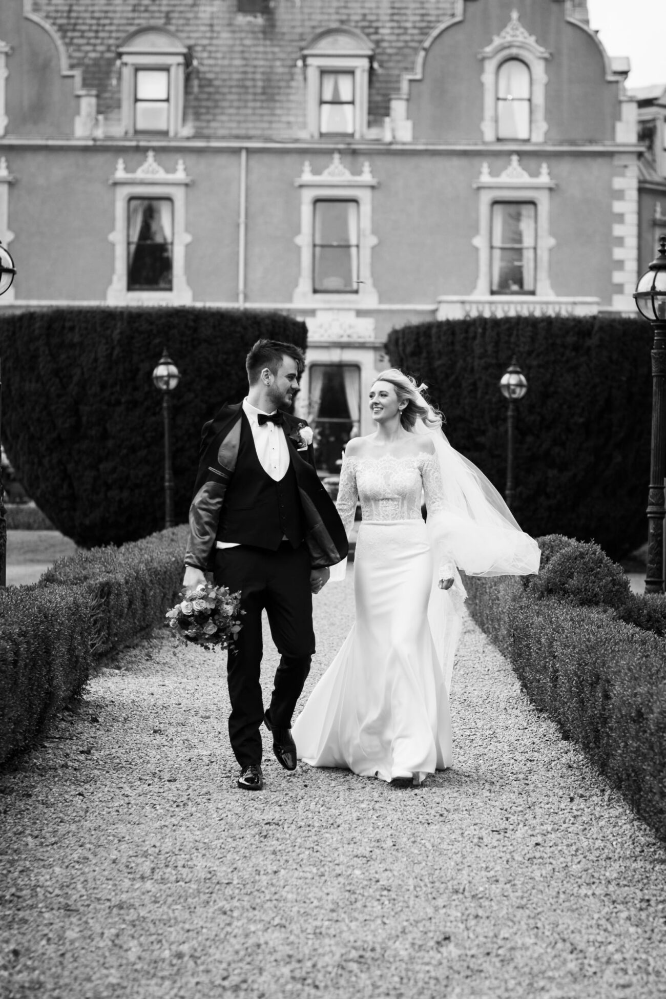 Bride and groom waking down the garden together on the grounds of Killashee Hotel, Killashee Hotel wedding