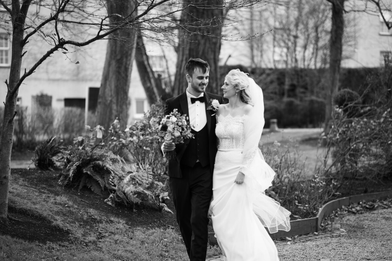 Bride and groom walking in the bridge garden together at Killashee Hotel