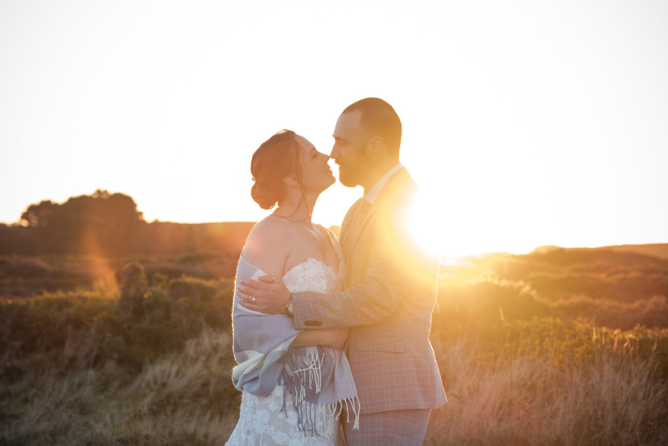 Vow renewal in Dublin on Howth summit, couple kissing against the sunset