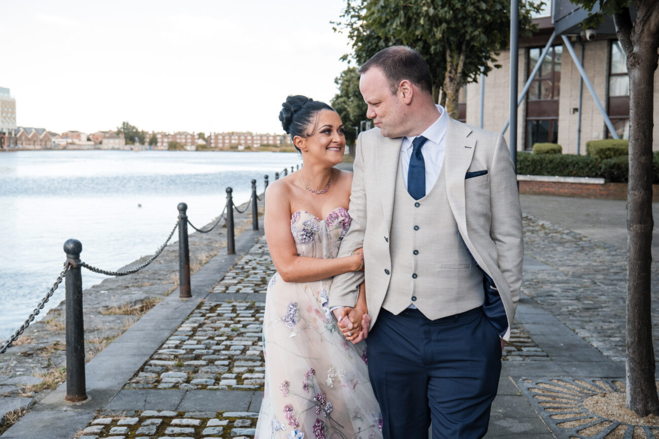 couple walking arm in arm and looking at each other at Charlotte Quay, Dublin, wedding at Charlotte Quay Dublin