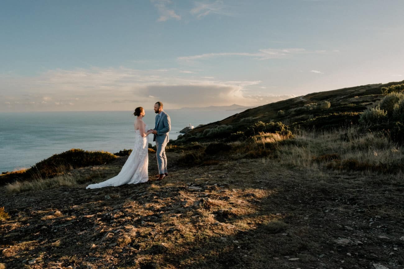 Couple exchnaging vows on Howth Summit as the sun sets