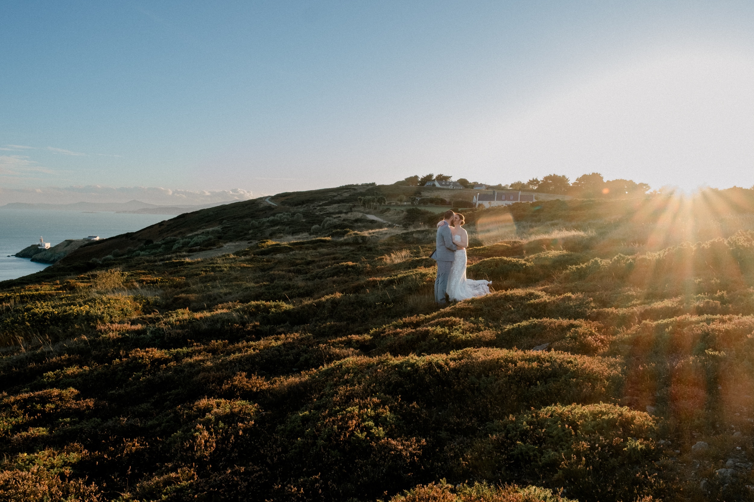 couple in the landscape of Howth Summit and the sunset in the background. Elopement photography in Howth