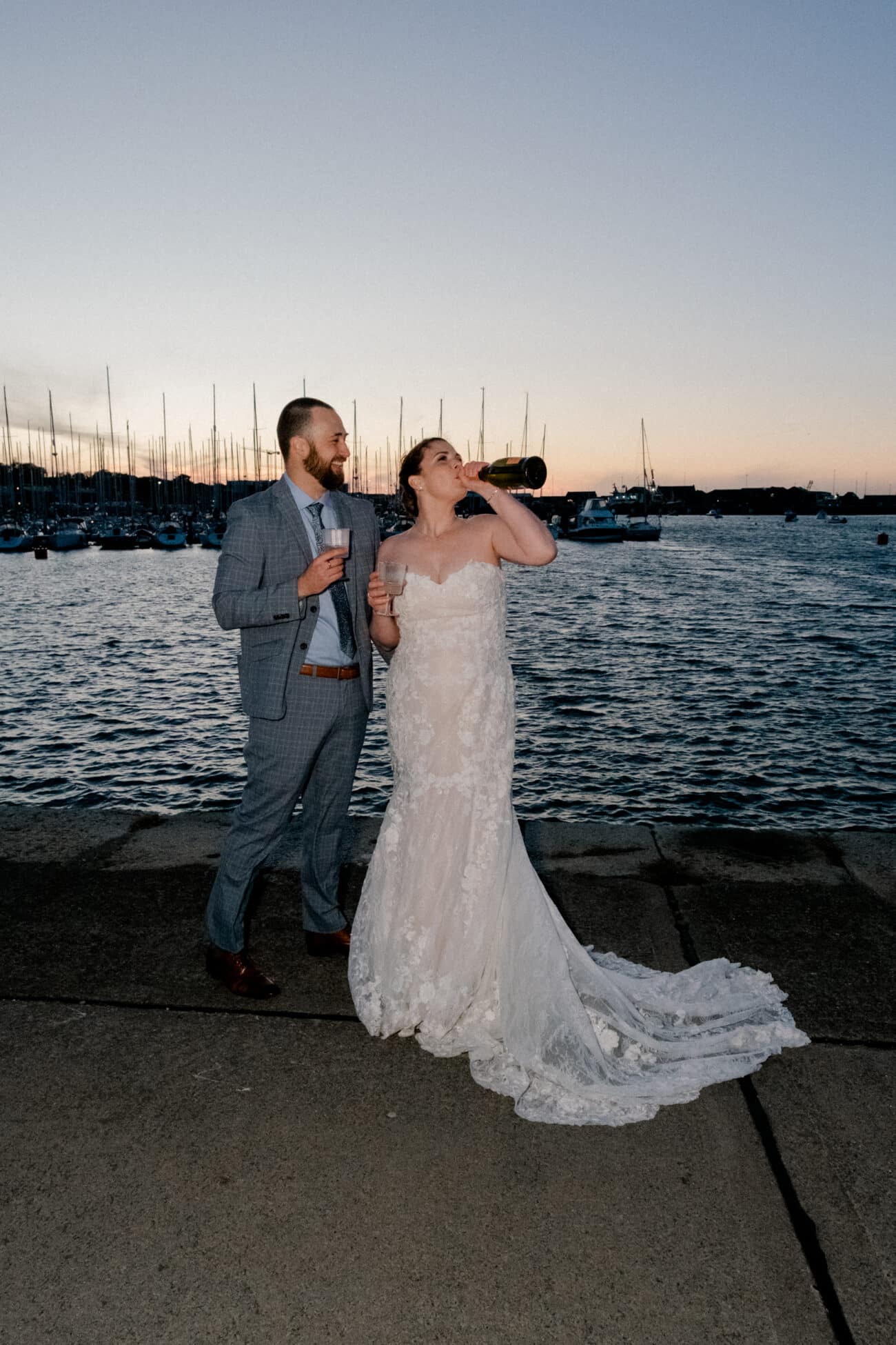 couple drining bubbles in the sunset of Howth Harbour