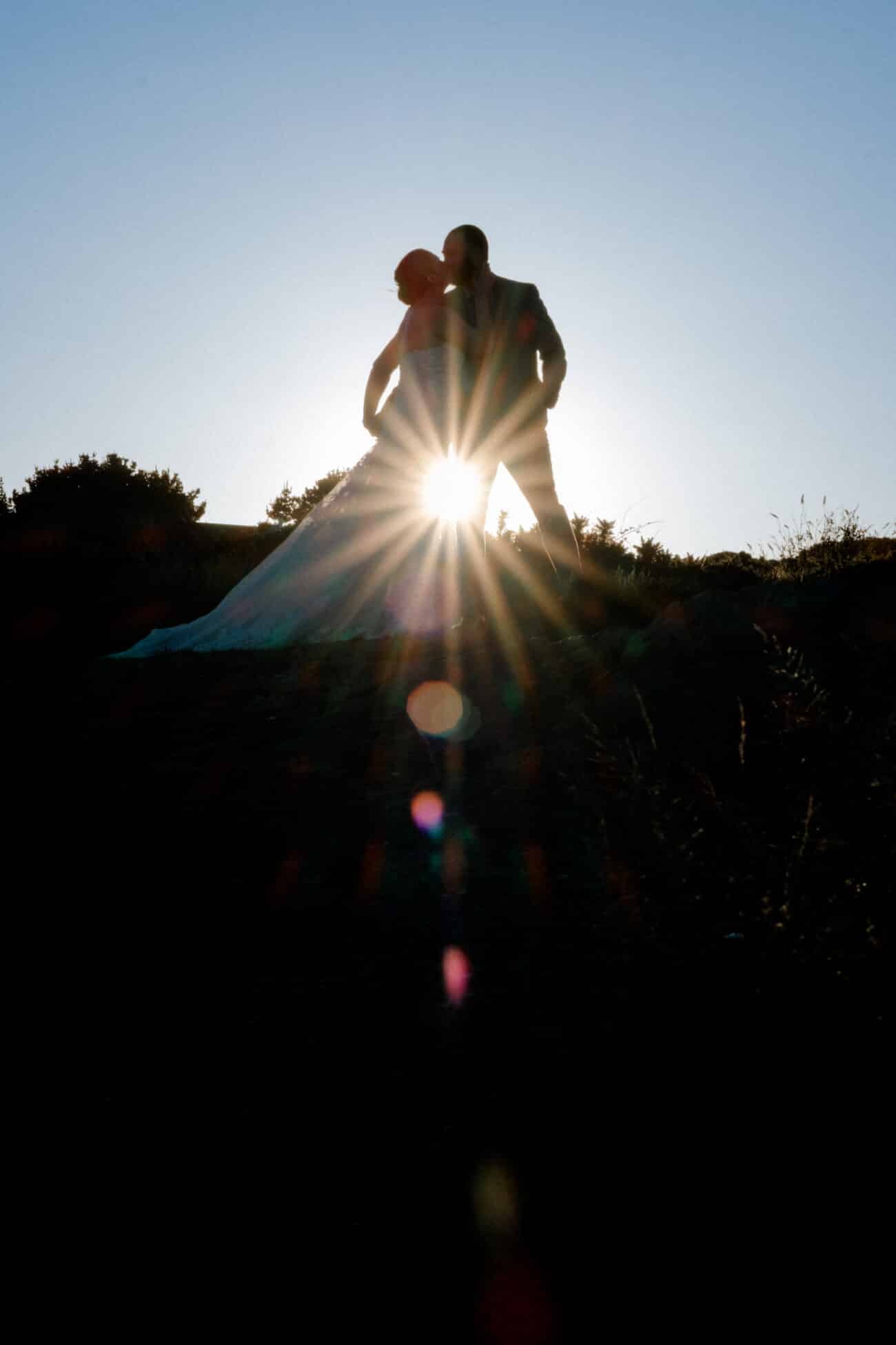 Couple silhouette kissing against the sunset in Howth Summit. Elopement Photography in Howth