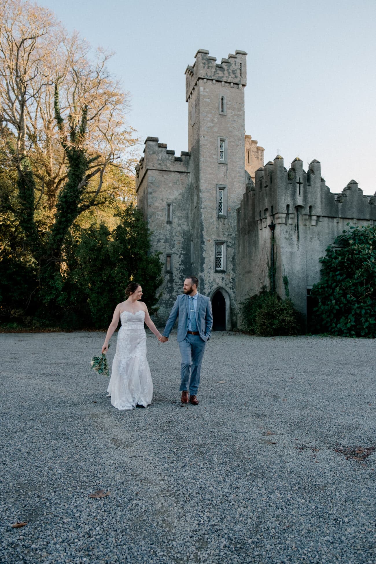 Couple walking and looking at each other with Howth Castle in the background