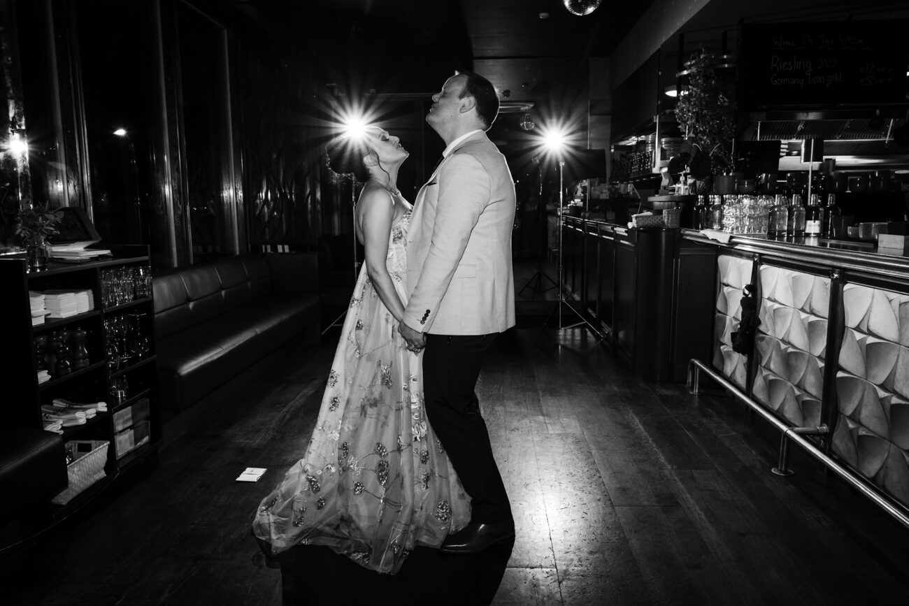 Couple singing and holding hands during their first dance at Charlotte Quay. Wedding photographer in Dublin. Candid wedding photography