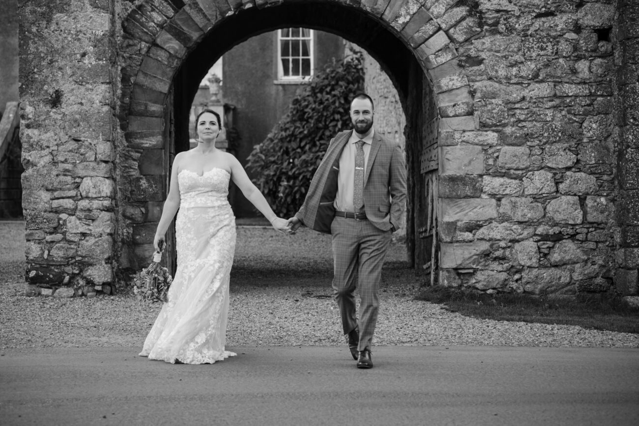 couple walking hand in hand outside of Howth Castle