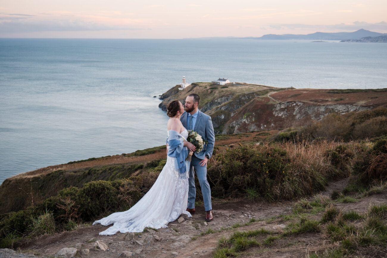 couple standing in front of the lighthouse at The Cliff of Howth